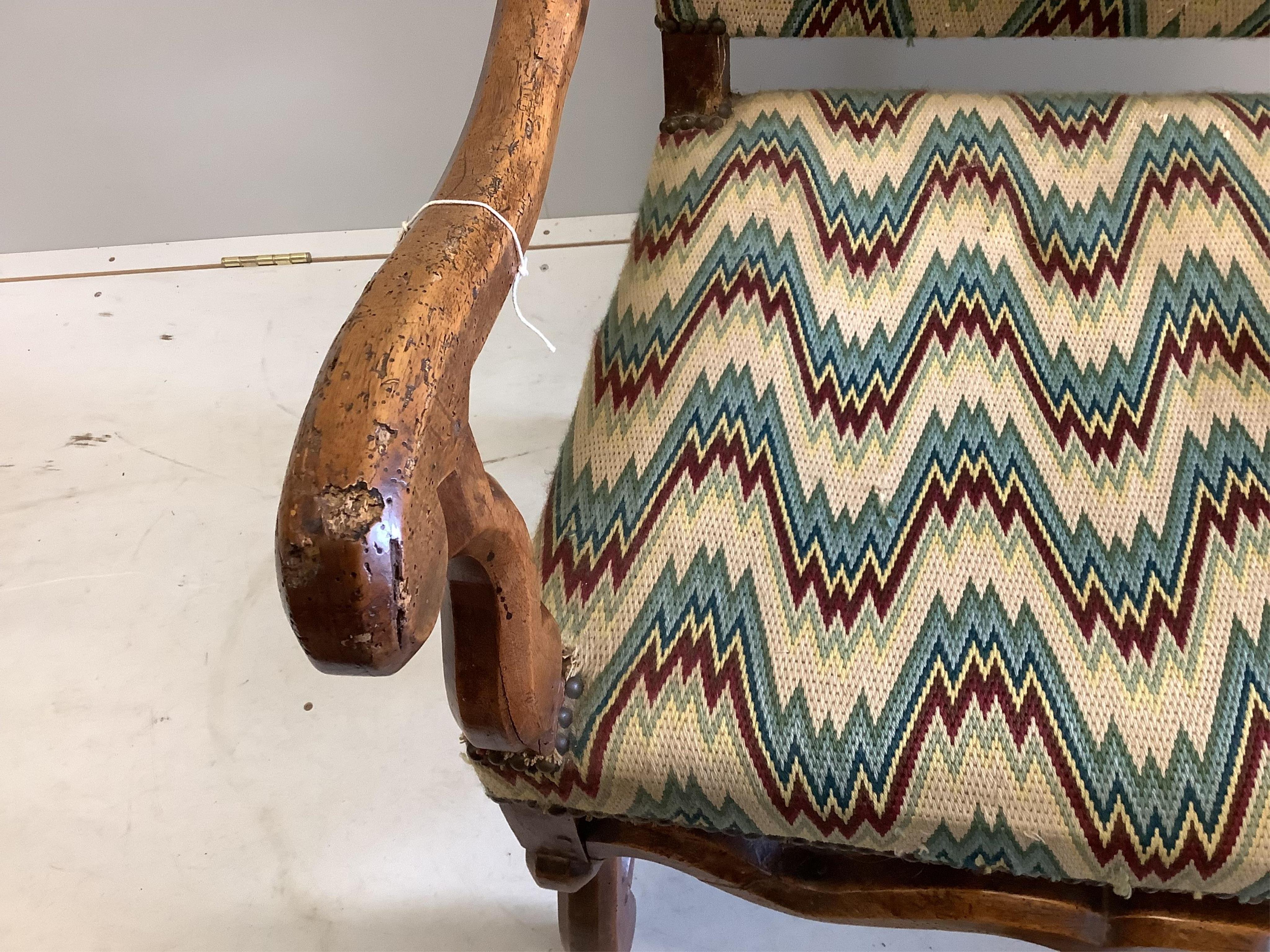 A 19th century French walnut armchair, in the 17th century style, width 64cm, height 116cm. Condition - heavily wormed, frame wobbling